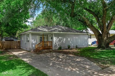 Single story home featuring covered porch and a front yard | Image 1