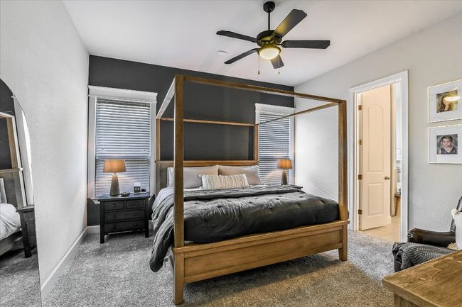 Bedroom featuring arched walkways, baseboards, carpet flooring, and ceiling fan | Image 16