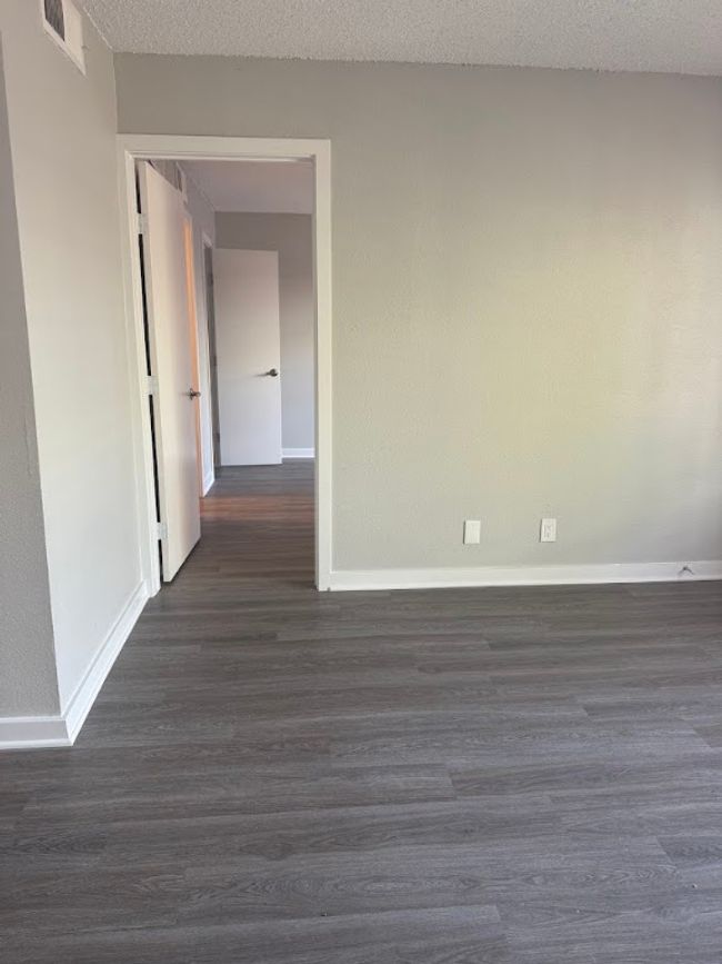 Empty room with baseboards and dark wood-style floors | Image 18