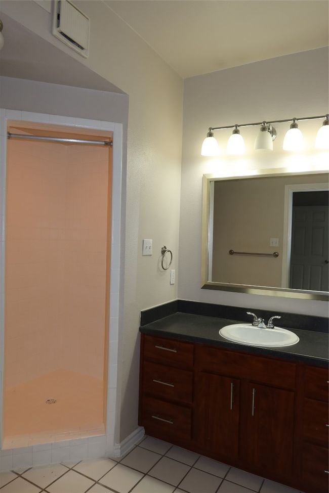 Bathroom featuring vanity, a stall shower, and tile patterned floors | Image 16