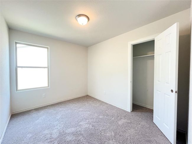 Inviting upstairs bedroom with soft carpeting for comfort. | Image 13