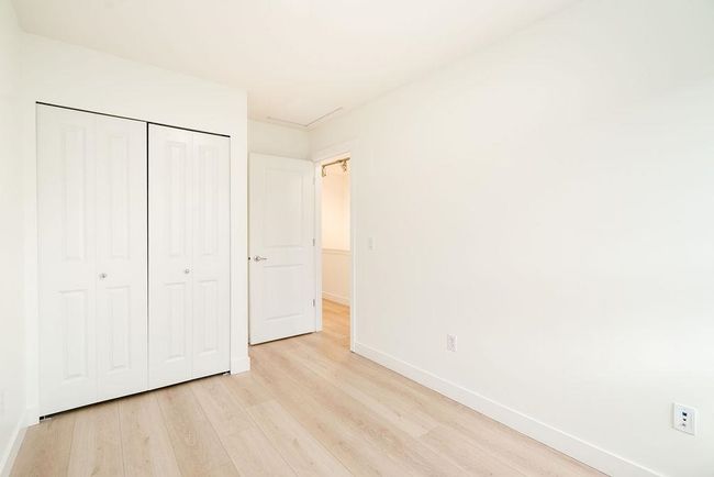 Unfurnished bedroom with a closet, baseboards, and light wood-style floors | Image 34