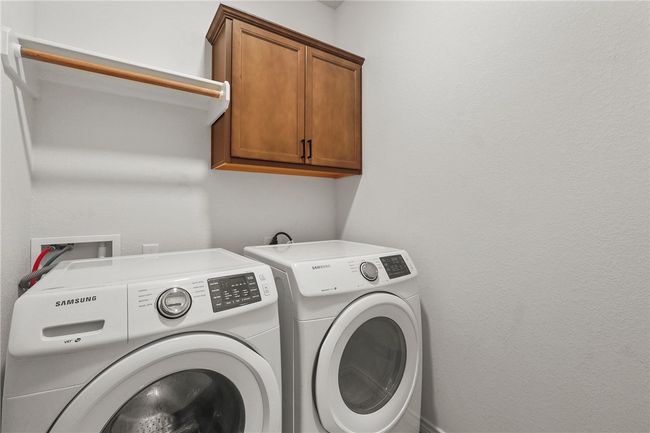 Washroom with cabinet space and washing machine and dryer | Image 10