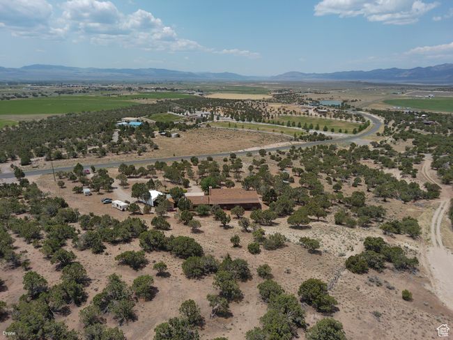 Aerial view of sparsely populated area with a mountainous background | Image 51