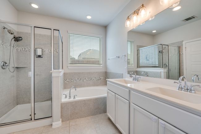 Bathroom featuring a bath, a shower stall, recessed lighting, and light tile patterned floors | Image 11