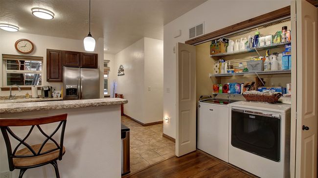 Laundry Closet adjacent to the kitchen. Extra shelving added for storage. | Image 27
