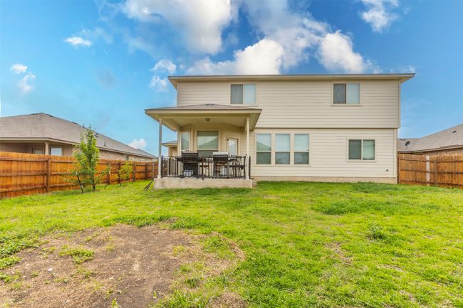 Rear view of property with a fenced backyard, a patio, and a lawn | Image 35