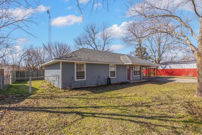 Back of property with a shingled roof, fence, a lawn, and siding | Image 26