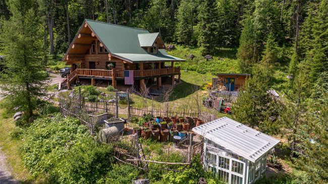 View from above of property featuring a heavily wooded area | Image 65