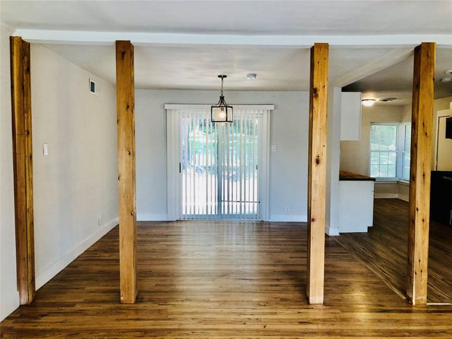 Unfurnished dining area featuring wood finished floors and plenty of natural light | Image 13