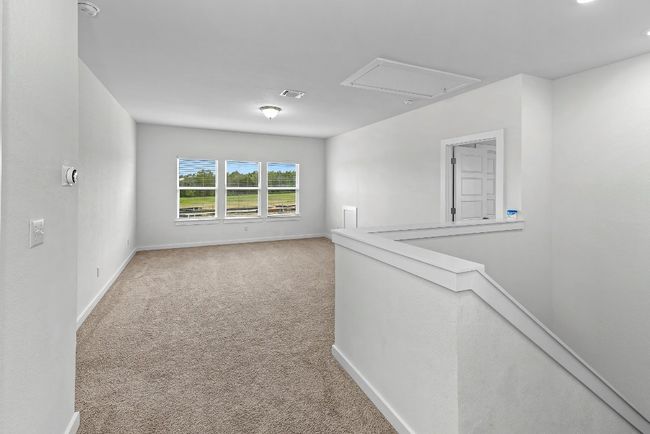 Unfurnished room with attic access, carpet flooring, baseboards, and a smoke detector | Image 26