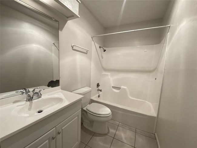 Bathroom featuring toilet, shower / bathtub combination, vanity, and tile floor. | Image 26