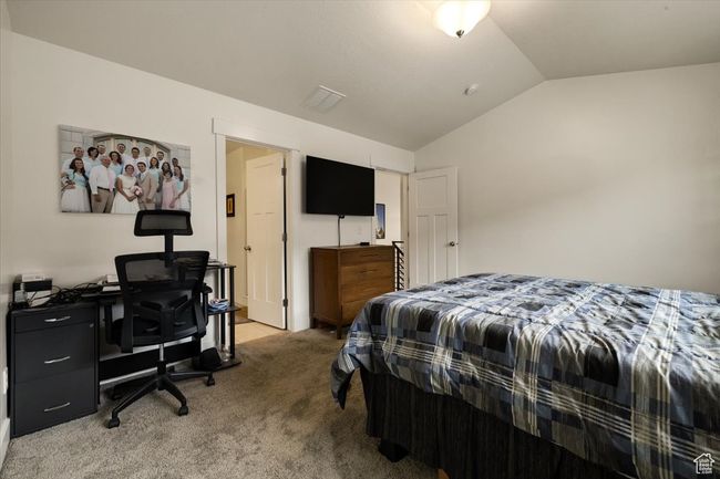Bedroom featuring lofted ceiling and carpet flooring | Image 14