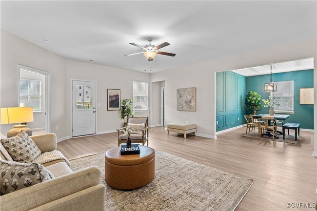 Living room with light wood-style floors, ceiling fan, and baseboards | Image 19