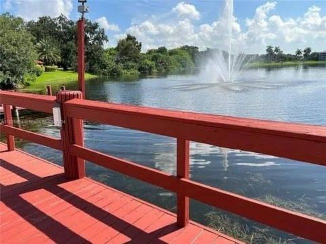 Clubhouse Pool Area Overlooking Lake And Water Fountain | Image 32