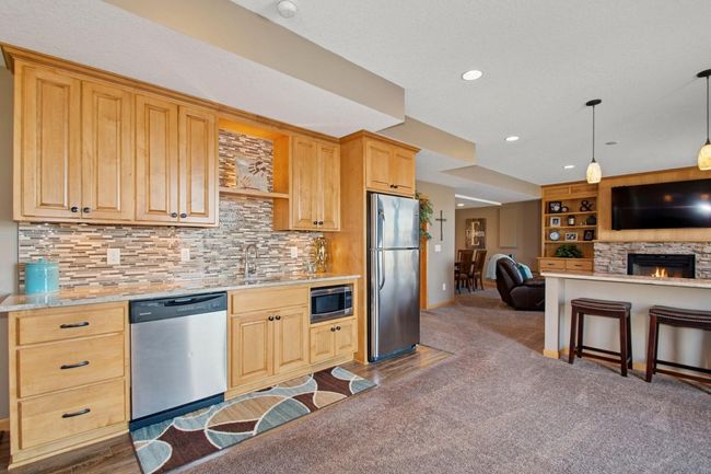 Wetbar with full refrigerator and dishwasher | Image 34