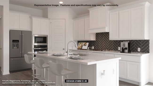 Kitchen featuring appliances with stainless steel finishes, white cabinets, tasteful backsplash, light countertops, and recessed lighting | Image 4