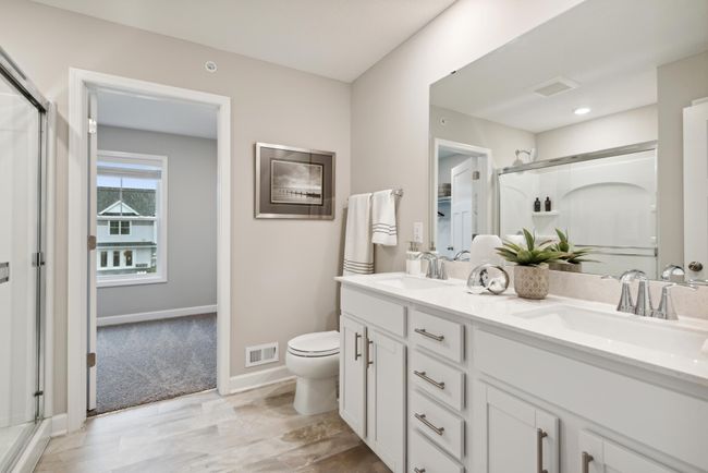Private owners suite bathroom with double sink vanity and walk in shower! *Photos are of a model home, some features and colors may vary. | Image 19