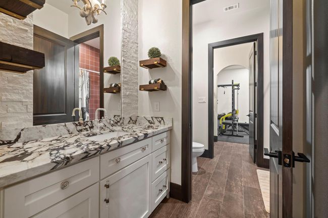 Jack and Jill bath looking into secondary bedroom that's currently being used as a gym | Image 33