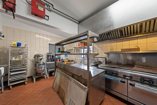 Kitchen featuring tile walls, open shelves, tile patterned flooring, and backsplash | Image 16