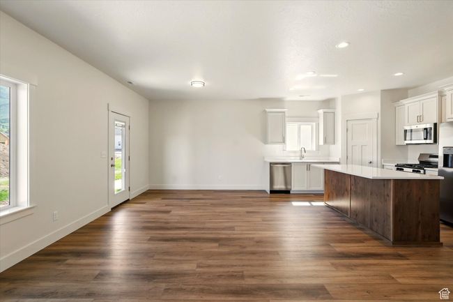 Kitchen featuring appliances with stainless steel finishes, plenty of natural light, a sink, light countertops, and recessed lighting | Image 7