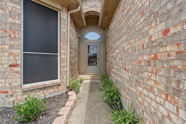 Entrance to property featuring brick siding | Image 5