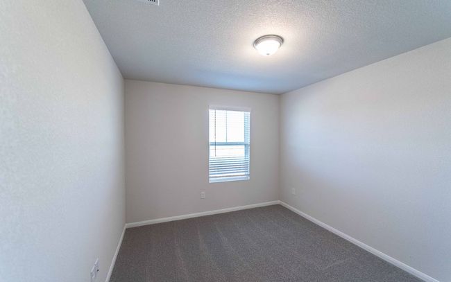 Empty room featuring dark colored carpet and a textured ceiling | Image 16