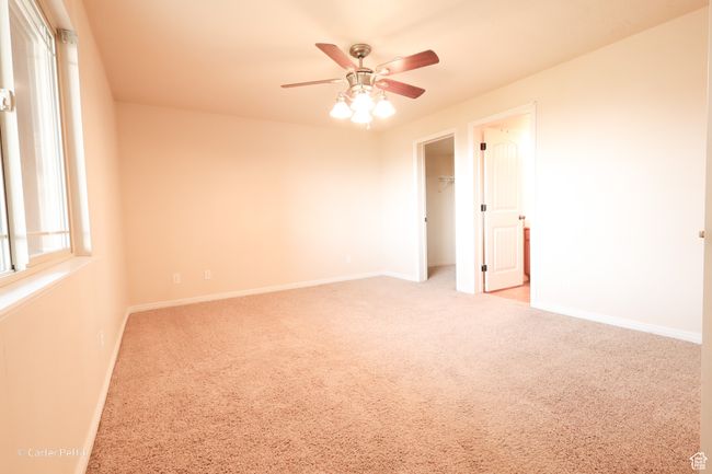 Carpeted empty room with ceiling fan and baseboards | Image 14