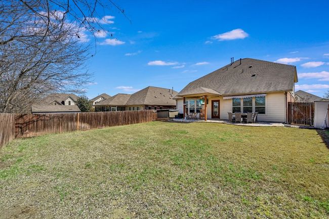 Rear view of house with a fenced backyard | Image 23