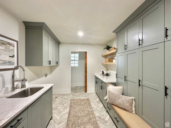 Laundry room with cabinet space, washer hookup, and brick floors | Image 18