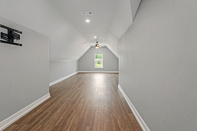 Additional living space with baseboards, lofted ceiling, dark wood-type flooring, ceiling fan, and recessed lighting | Image 29