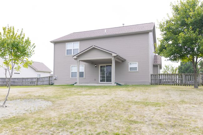 rear view of house with a fenced backyard | Image 31