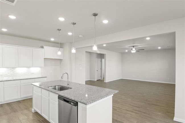Kitchen with light wood-type flooring, dishwasher, a sink, and a ceiling fan | Image 12