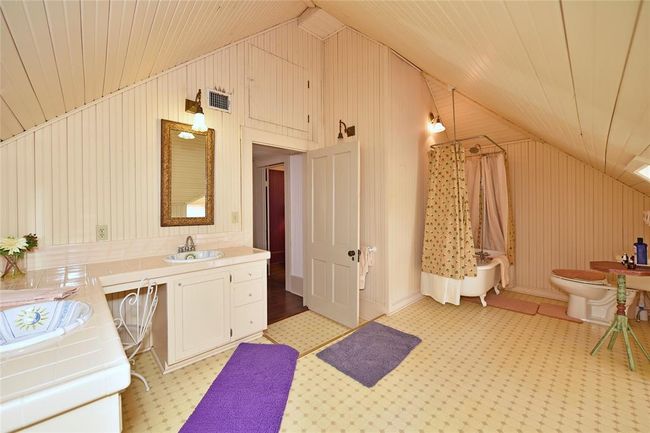 This is the upstairs bathroom in the Main house. There is an original claw-foot tub/shower, double vanities and plenty of room. | Image 19