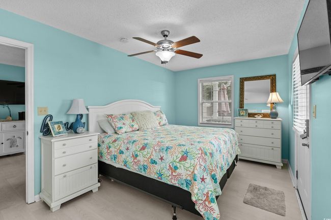 Bedroom featuring a textured ceiling, baseboards, and a ceiling fan | Image 16