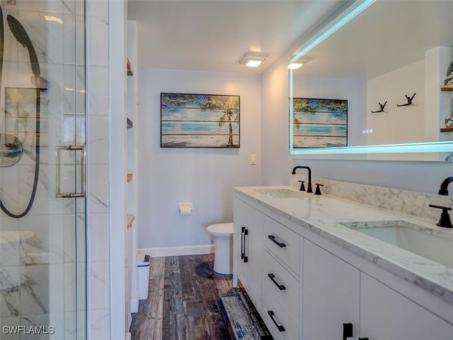 OWNER'S SUITE BATH. MARBLE-TOPPED DUAL SINK VANITY. ANTI-FOG BACK-LIT MIRROR. | Image 25