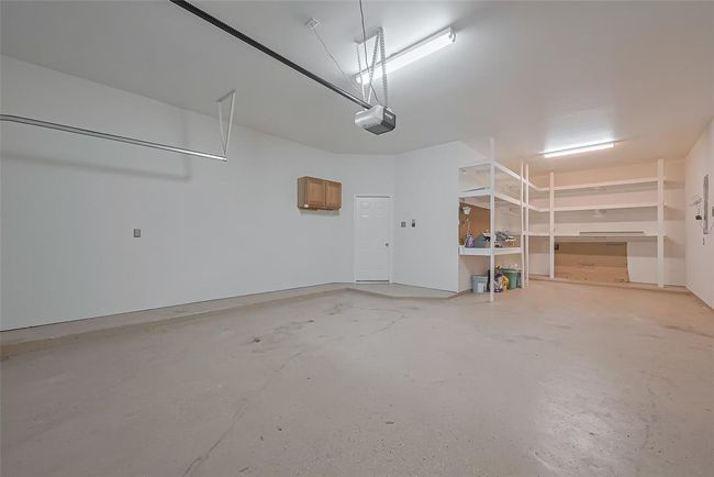 Garage with storage area. | Image 38