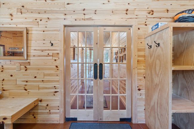 Glass doors separating bedrooms from Great Room | Image 21