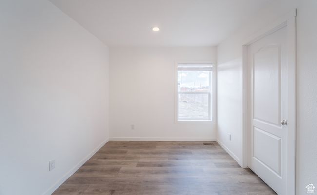 Empty room with recessed lighting, baseboards, and wood finished floors | Image 10