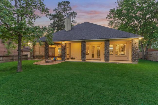 Enjoy the extended back porch area, thoughtfully designed with both open and screened-in sections—perfect for relaxing in the shade, entertaining guests, or simply taking in the serene views year-round. | Image 39