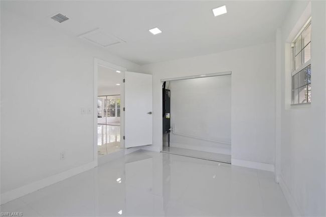 Unfurnished room featuring attic access, visible vents, and baseboards | Image 10