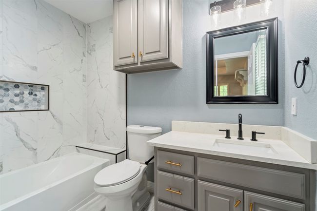 Bathroom featuring vanity, toilet, and shower / bathtub combination | Image 27