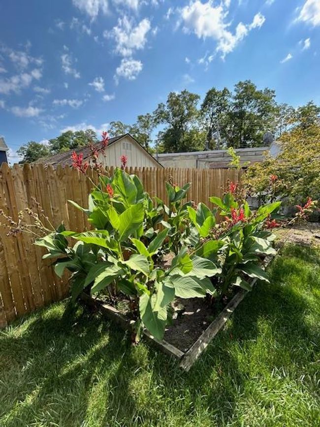 View of yard featuring plantings and fence | Image 33