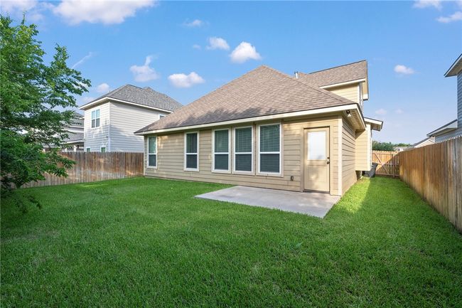 Back of house with roof with shingles, a patio area, and a fenced backyard | Image 25