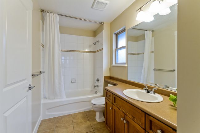 Bathroom featuring visible vents, vanity, shower / bath combo with shower curtain, toilet, and tile patterned floors | Image 23