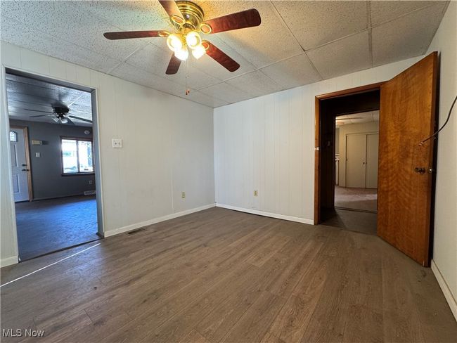 Unfurnished room with baseboards, visible vents, ceiling fan, and wood finished floors | Image 14