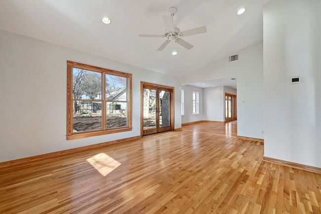 Unfurnished living room with visible vents, light wood-style flooring, recessed lighting, baseboards, and ceiling fan | Image 9