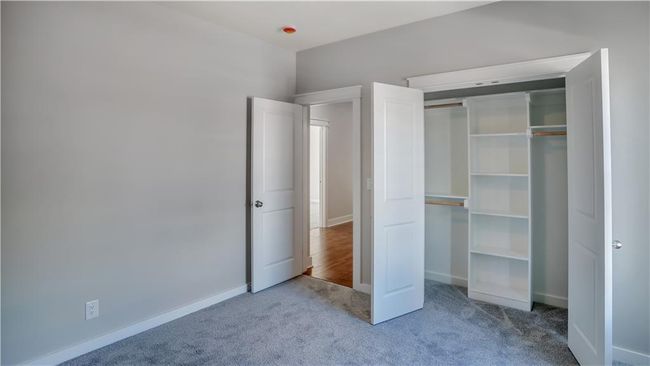 Unfurnished bedroom with carpet flooring, a closet, and baseboards | Image 14