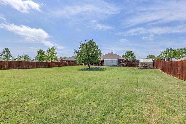 View of yard featuring a fenced backyard and an outdoor structure | Image 39