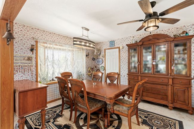 Dining room featuring wallpapered walls and ceiling fan | Image 42